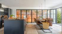 The walls of glass are a striking feature and the giant dining-table will make a wonderful spot for some indulgent feasting.