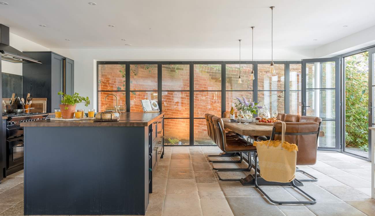 The walls of glass are a striking feature and the giant dining-table will make a wonderful spot for some indulgent feasting.