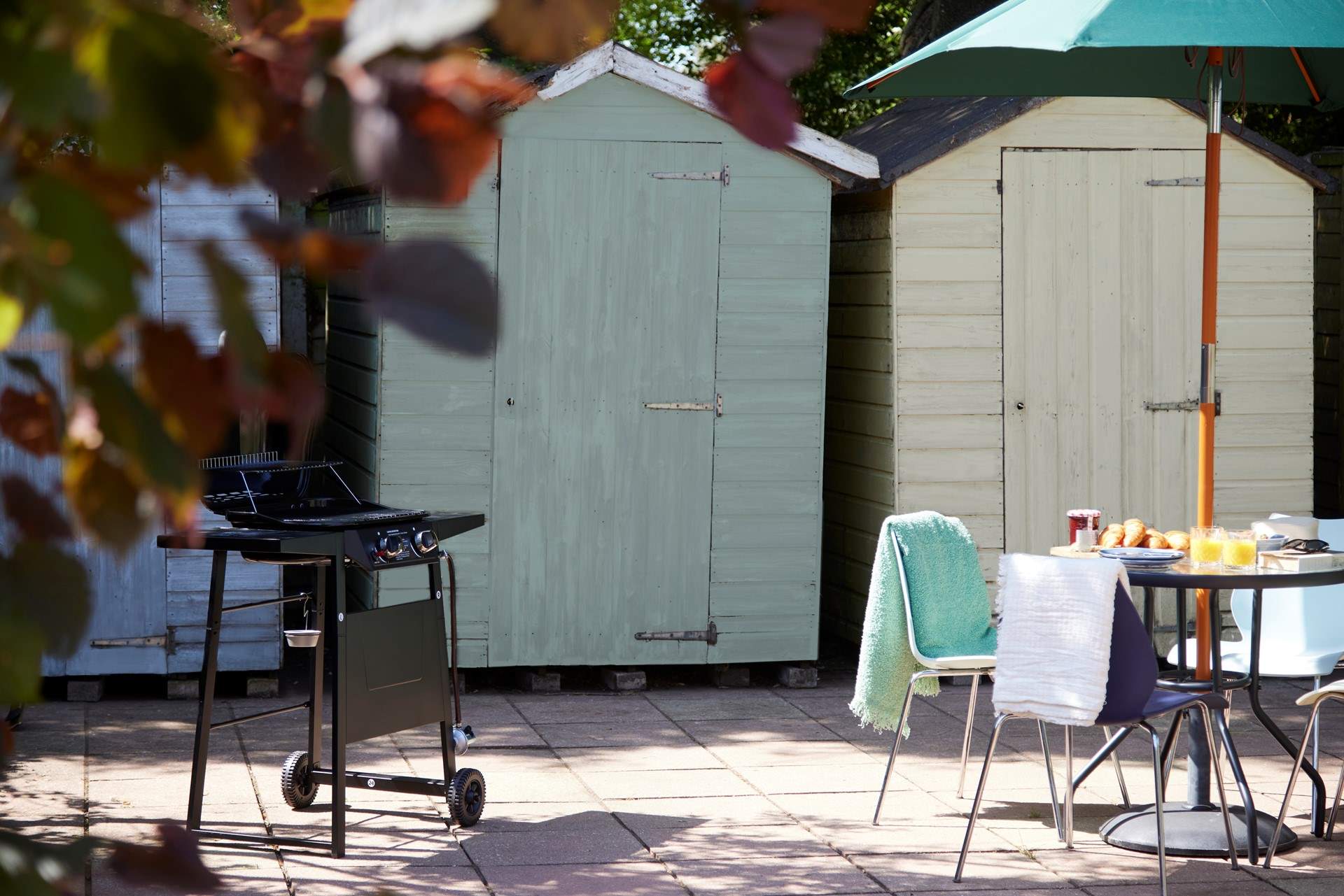 How about a bit of open air dining or a barbecue? The beach hut storage sheds are a little reminder that the sea is just around the corner...