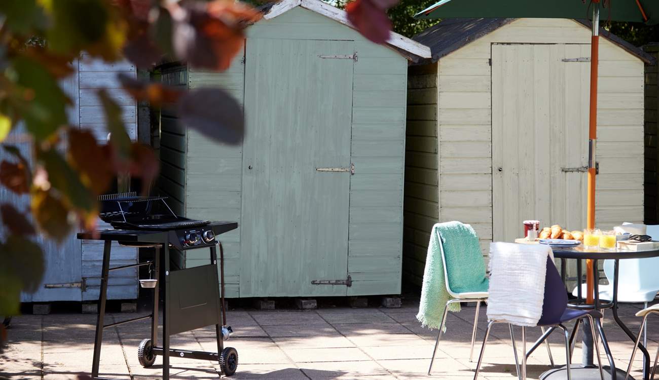 How about a bit of open air dining or a barbecue? The beach hut storage sheds are a little reminder that the sea is just around the corner...