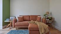 Soft furnishings and a curated palette create a wonderful place to cosy up and rest your limbs after a day exploring.
