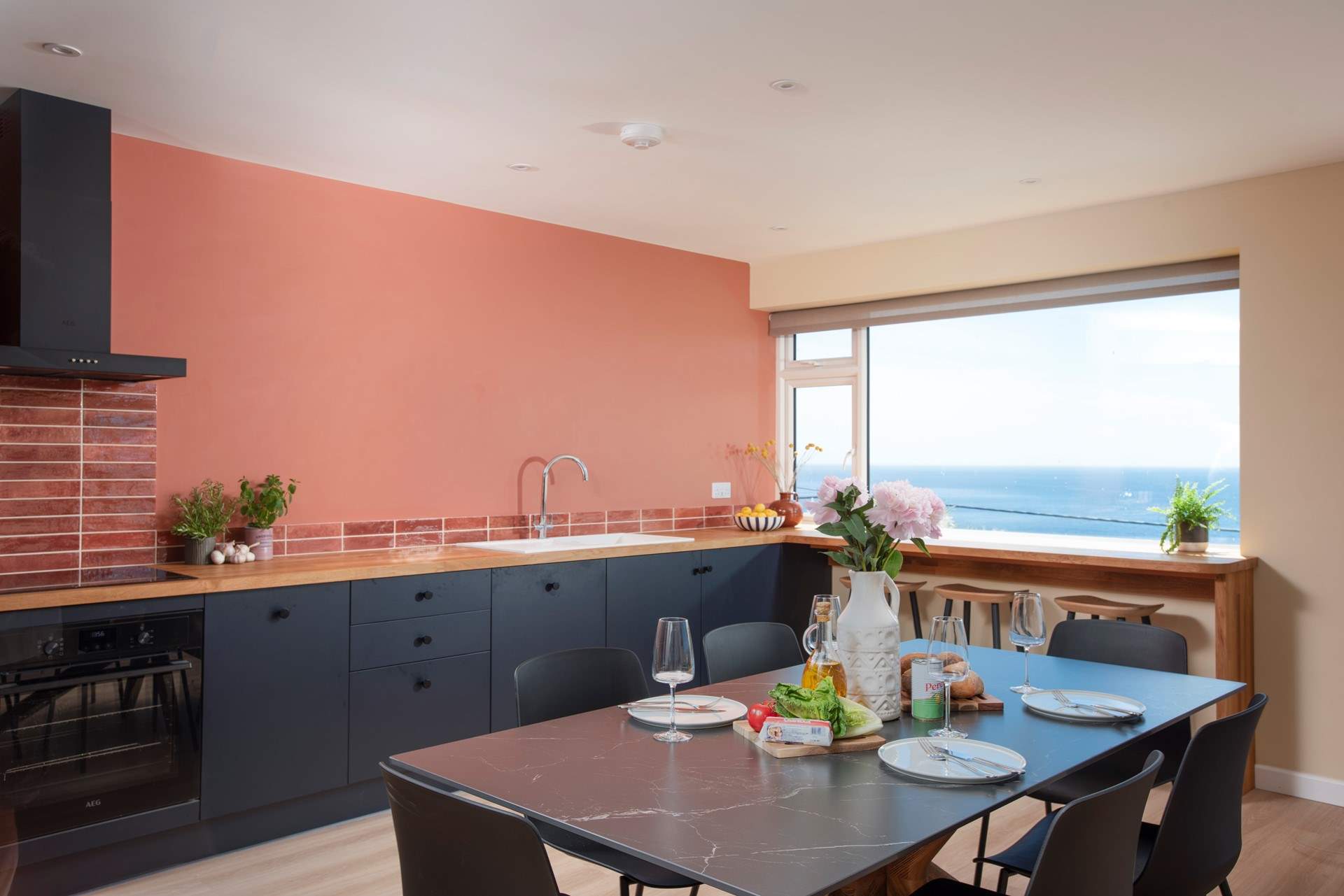 The spacious kitchen and dining area is perfectly positioned to make the most of the views across the sea.