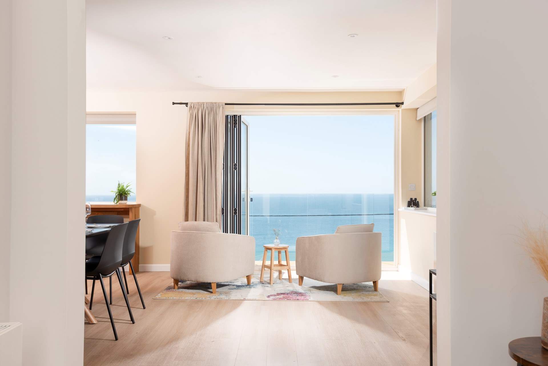 Comfortable seating beside the bi-fold doors provides the perfect place to relax and enjoy the view.