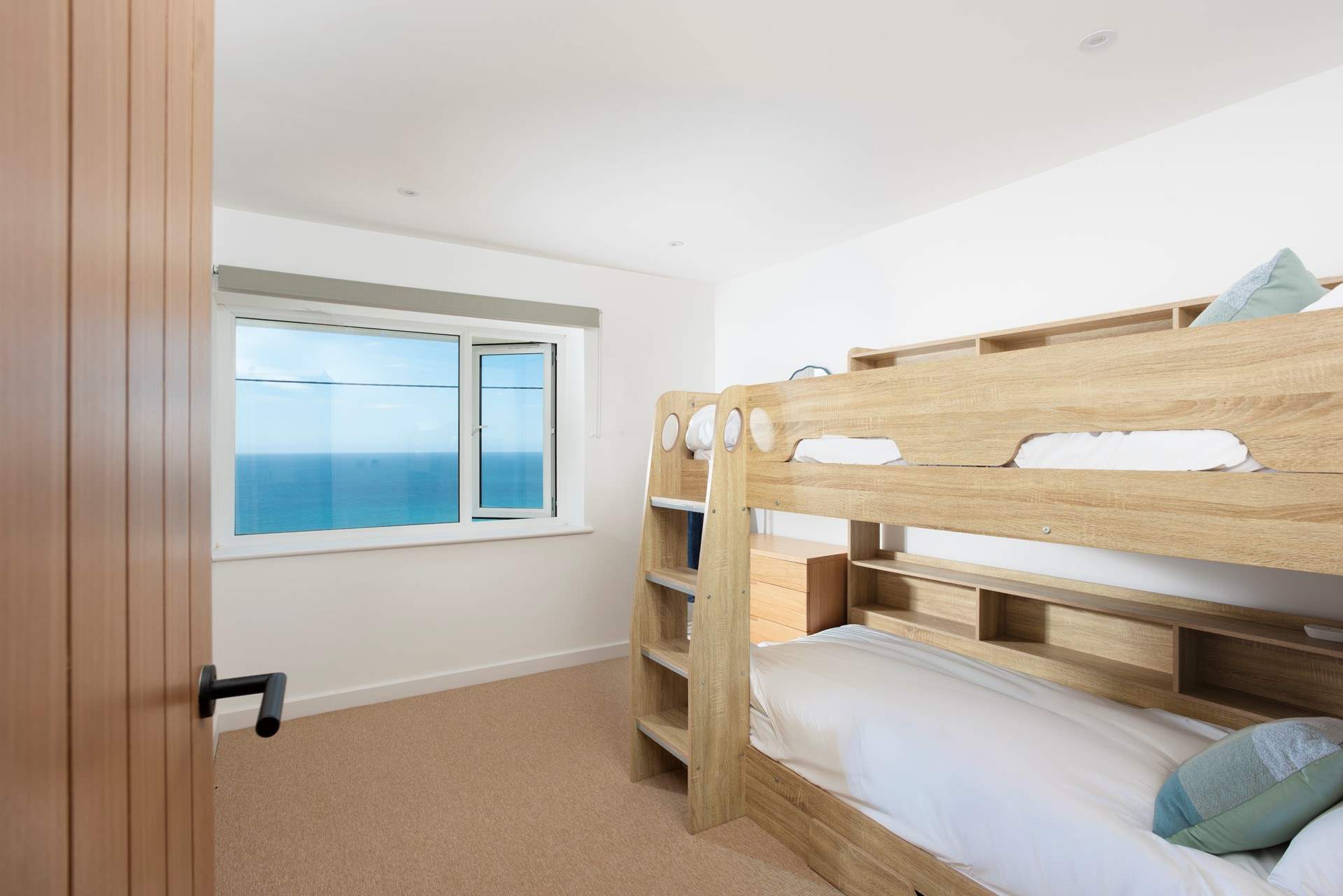 Bedroom 2 has stylish bunkbeds overlooking the sea.