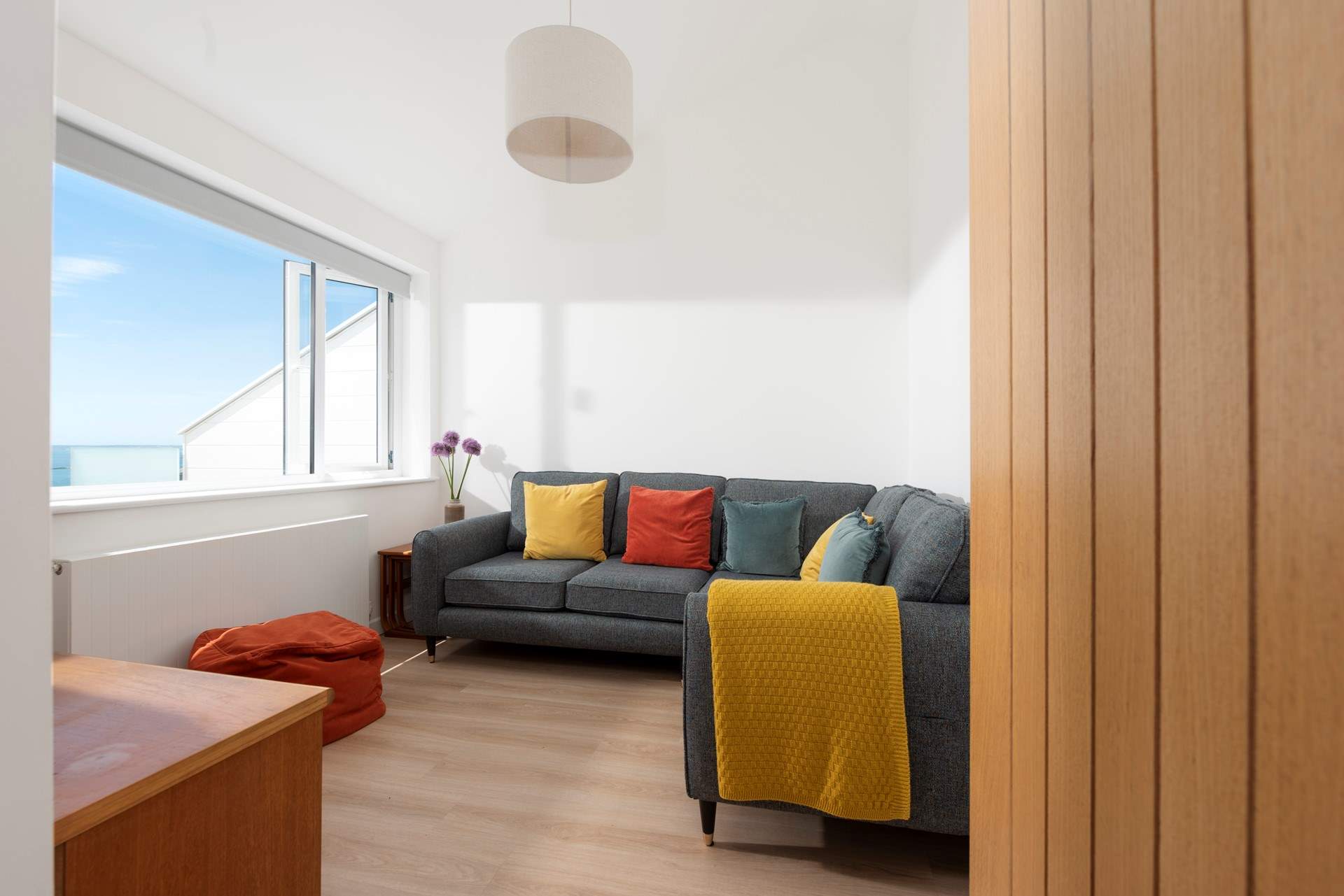 The cosy sitting-room is the perfect place to unwind after a day exploring the coast.