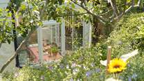 Glimpses down from the garden to the dining space in the sun-room.