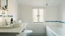 The family bathroom is bright and spacious.