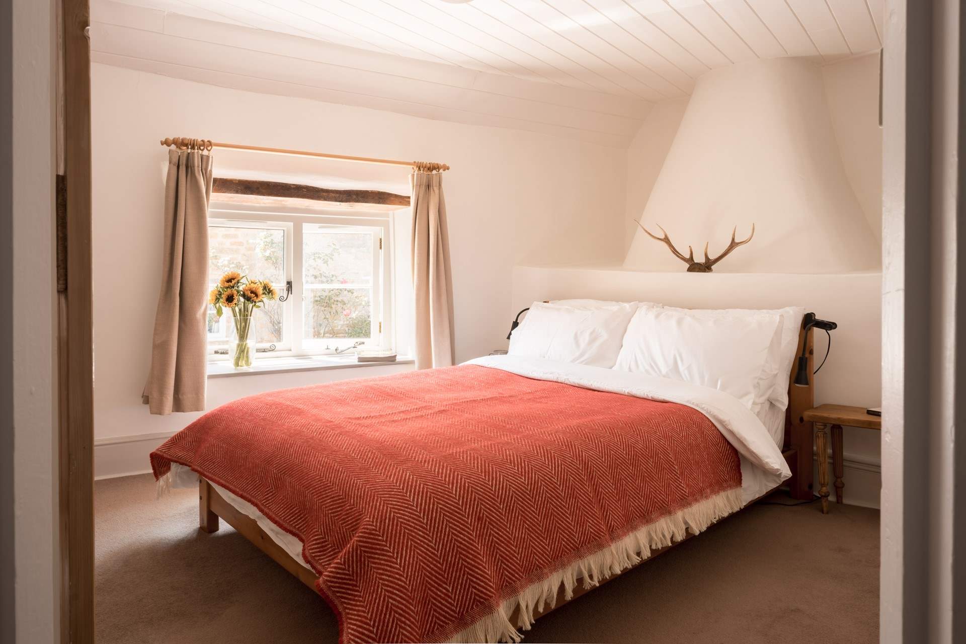 The main bedroom is beautiful and spacious with a storage/hanging area and inviting double bed.
