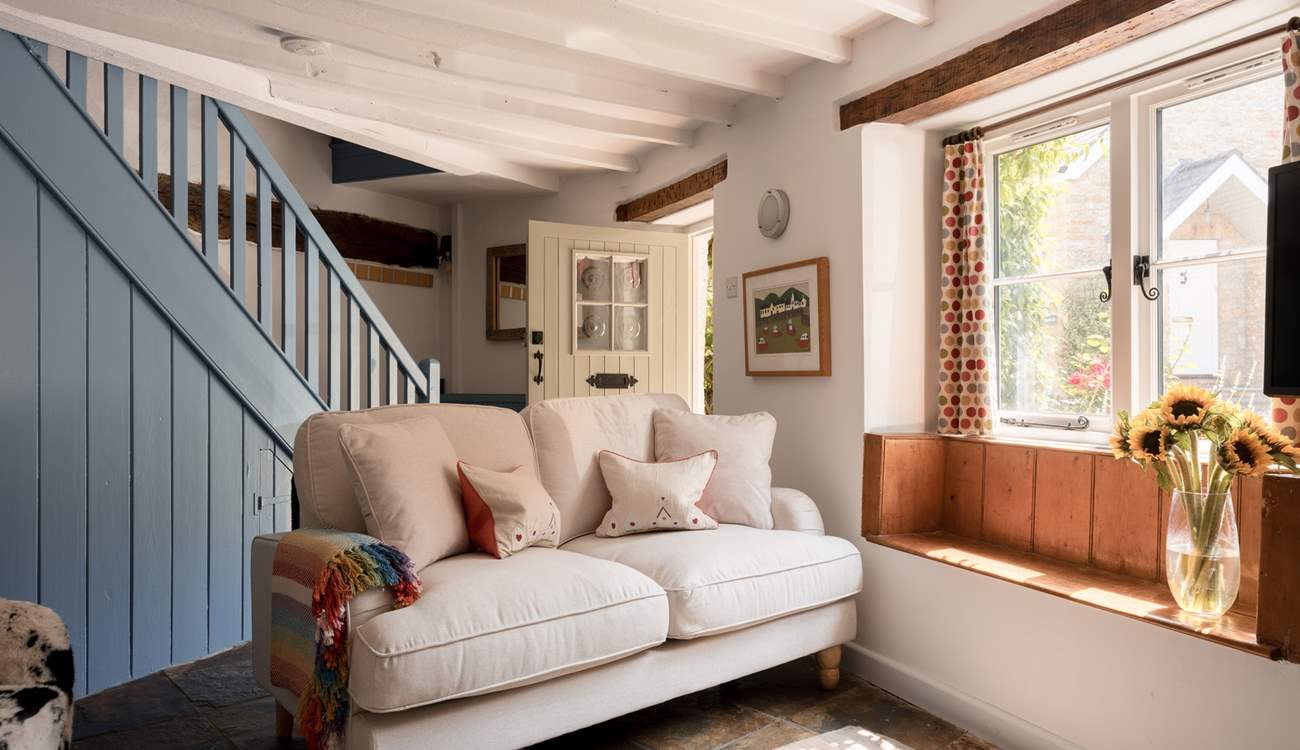 The sitting-room is just right for four guests and packed with original features and charm. Imagine a morning coffee with a book sat in the window seat...