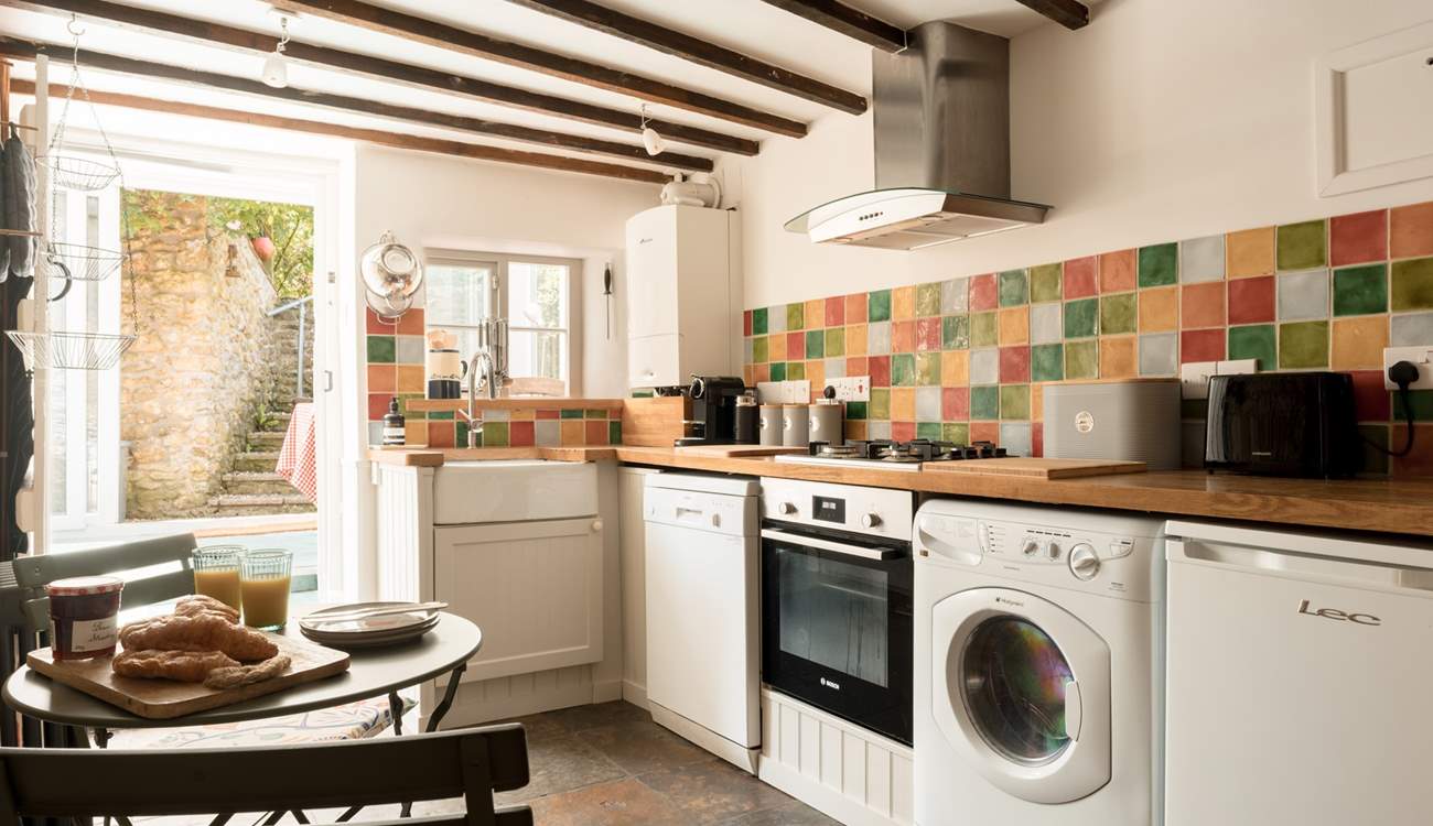 The simple cottage kitchen has everything you would expect from a well thought through space, and has a wonderful flow through into the sun-room and garden beyond...