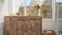 The use of sympathetic natural materials is on evidence throughout... Note that you will find all your crockery, cutlery and glassware in this sideboard.