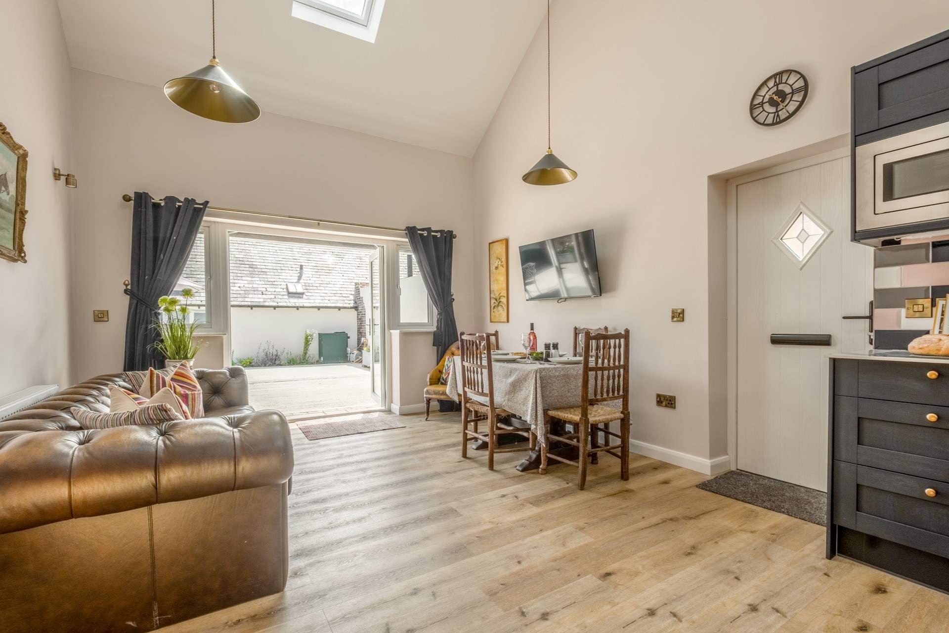 The open plan living area has double doors leading to a spacious courtyard garden.