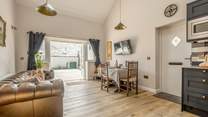 The open plan living area has double doors leading to a spacious courtyard garden.