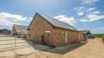 The Old Tractor Shed is on a traditional working farm with sheep and horses..