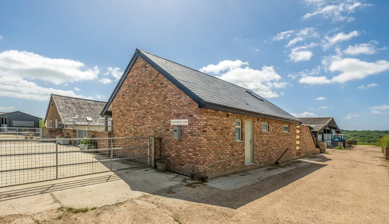 The Old Tractor Shed is on a traditional working farm with sheep and horses..