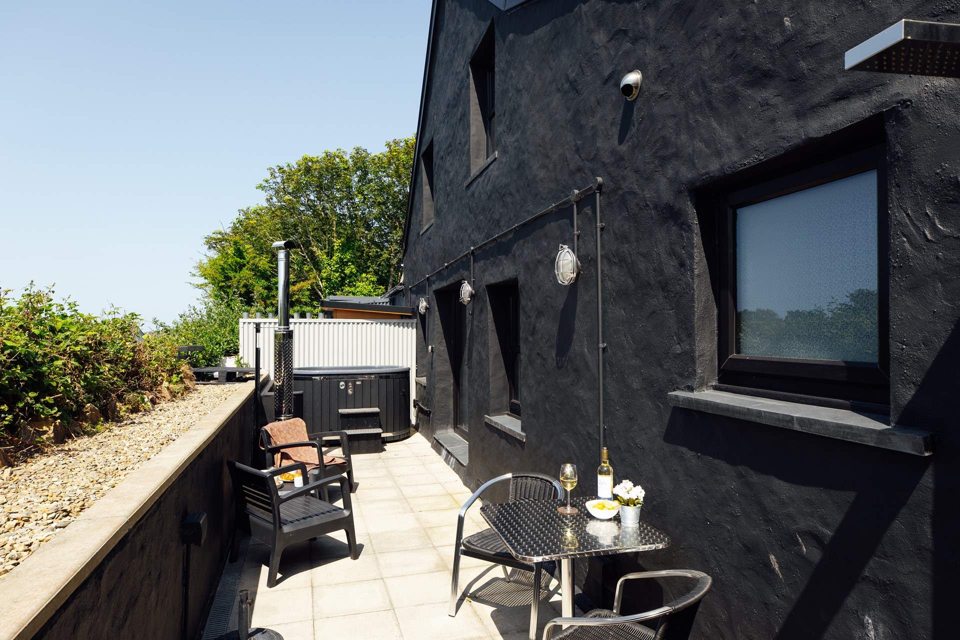 The sunny patio at Nol with sauna and wood-fired hot tub. The perfect spot under the dark Pembrokeshire skies to star gaze on a still summer's night. 