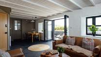 Throw open the bi-fold doors onto the patio in the larger sitting room in Nol. 
