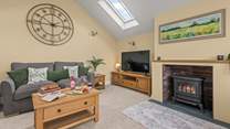 Snuggle up in front of the wood-burner effect electric stove on those chillier evenings.