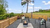 Another fabulous seating-area equipped with a fire-pit/barbecue.