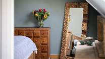 The full length mirror reflects the room and is great for those last minute clothing adjustments.