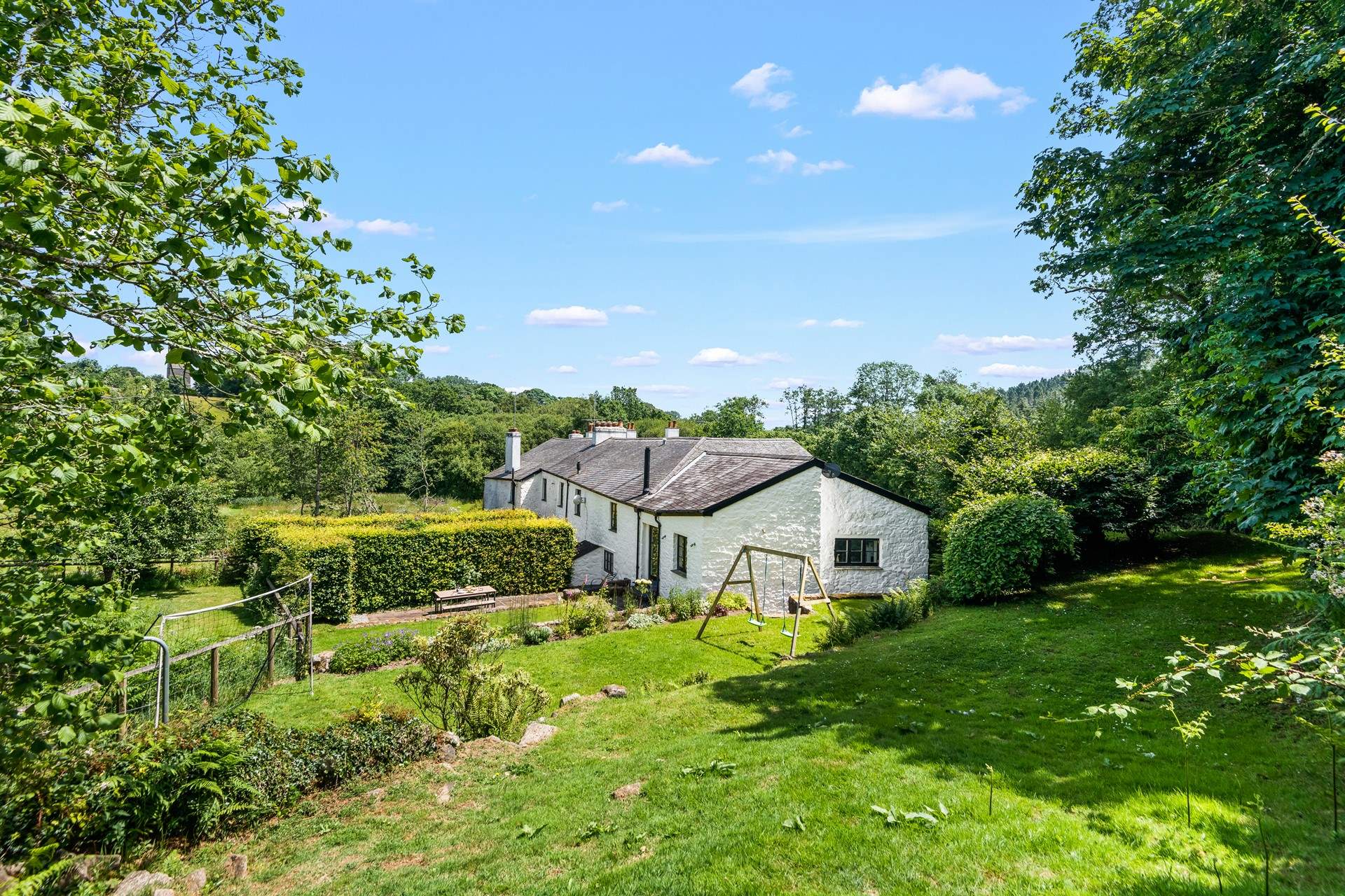The garden backs onto the grounds of Bovey Castle. This row of cottages enjoy an historic relationship with Bovey Castle.