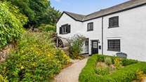 Once through the gate, make your way down the path to New Mill, proudly awaiting your arrival.
