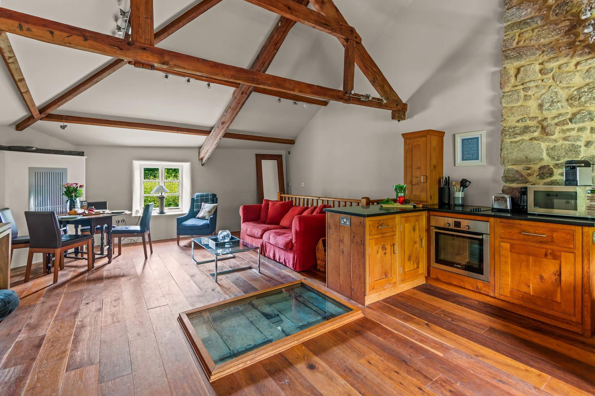 Heading upstairs, you are welcomed into this spacious living area. The focal point being the hatch which is preserved and showcased within the floor space, please mind your step as the casing is raised.