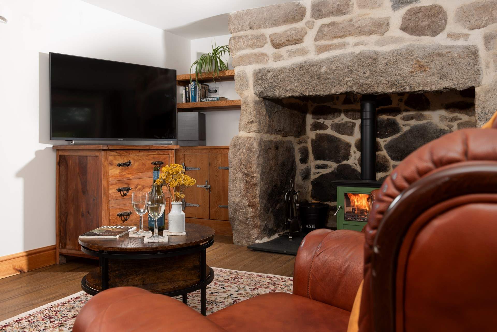 The sitting-room has a warming wood-burner.