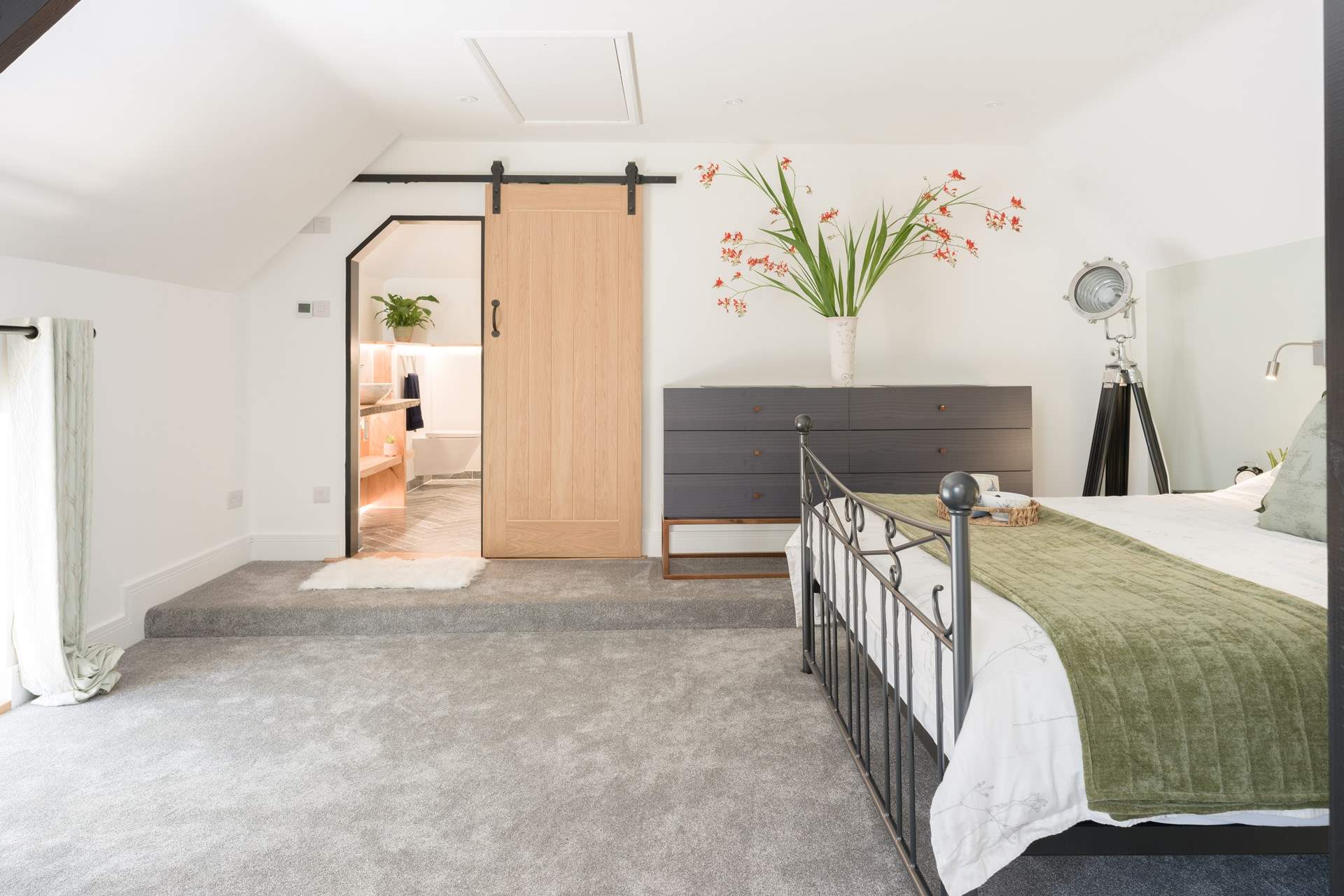 The bedroom has a gorgeous en suite shower-room with a large rainfall shower.