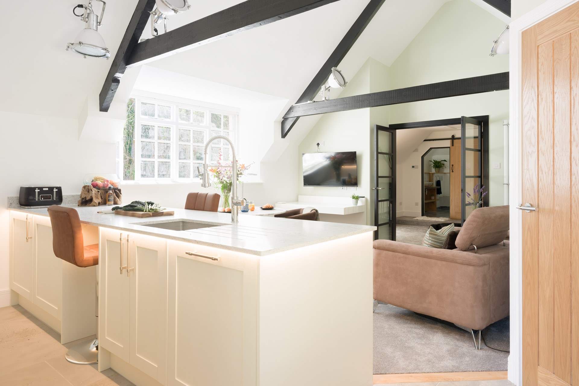The open plan living-room, with vaulted ceiling, is flooded with natural light.