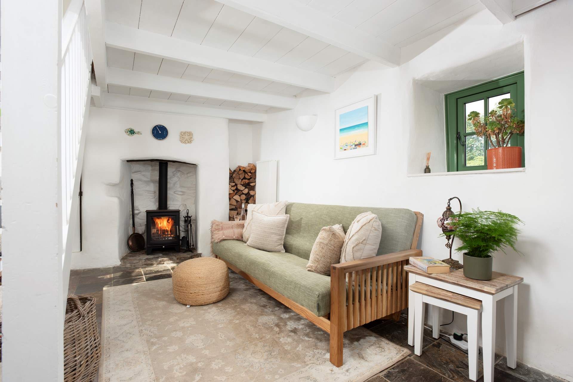 The sweet sitting-room with a cosy wood-burner. 