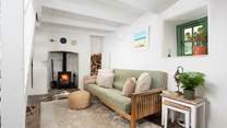 The sweet sitting-room with a cosy wood-burner. 