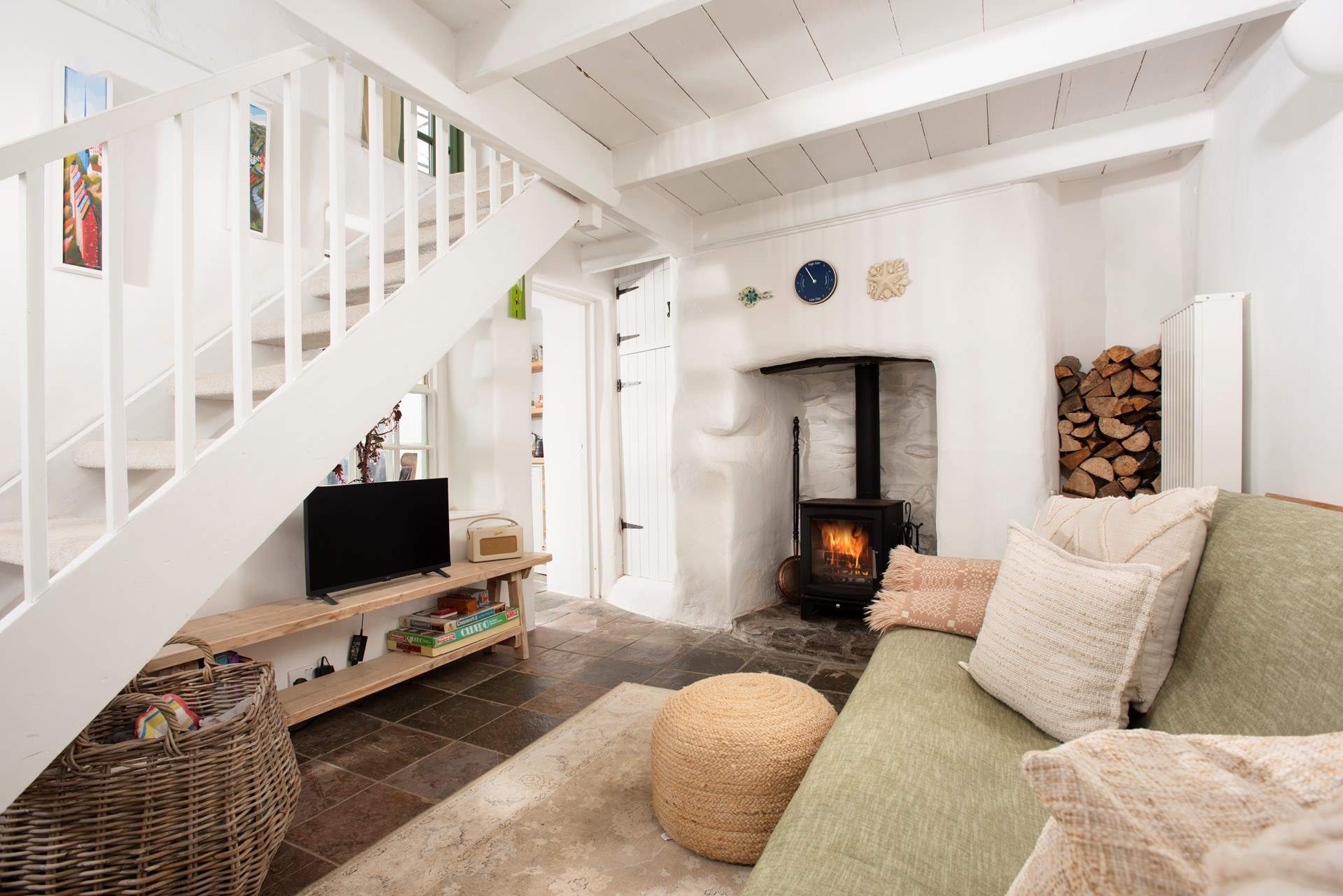 The charming sitting-room leads to the kitchen/diner and the stairs to the bedroom and shower-room. 