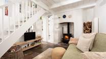 The charming sitting-room leads to the kitchen/diner and the stairs to the bedroom and shower-room. 