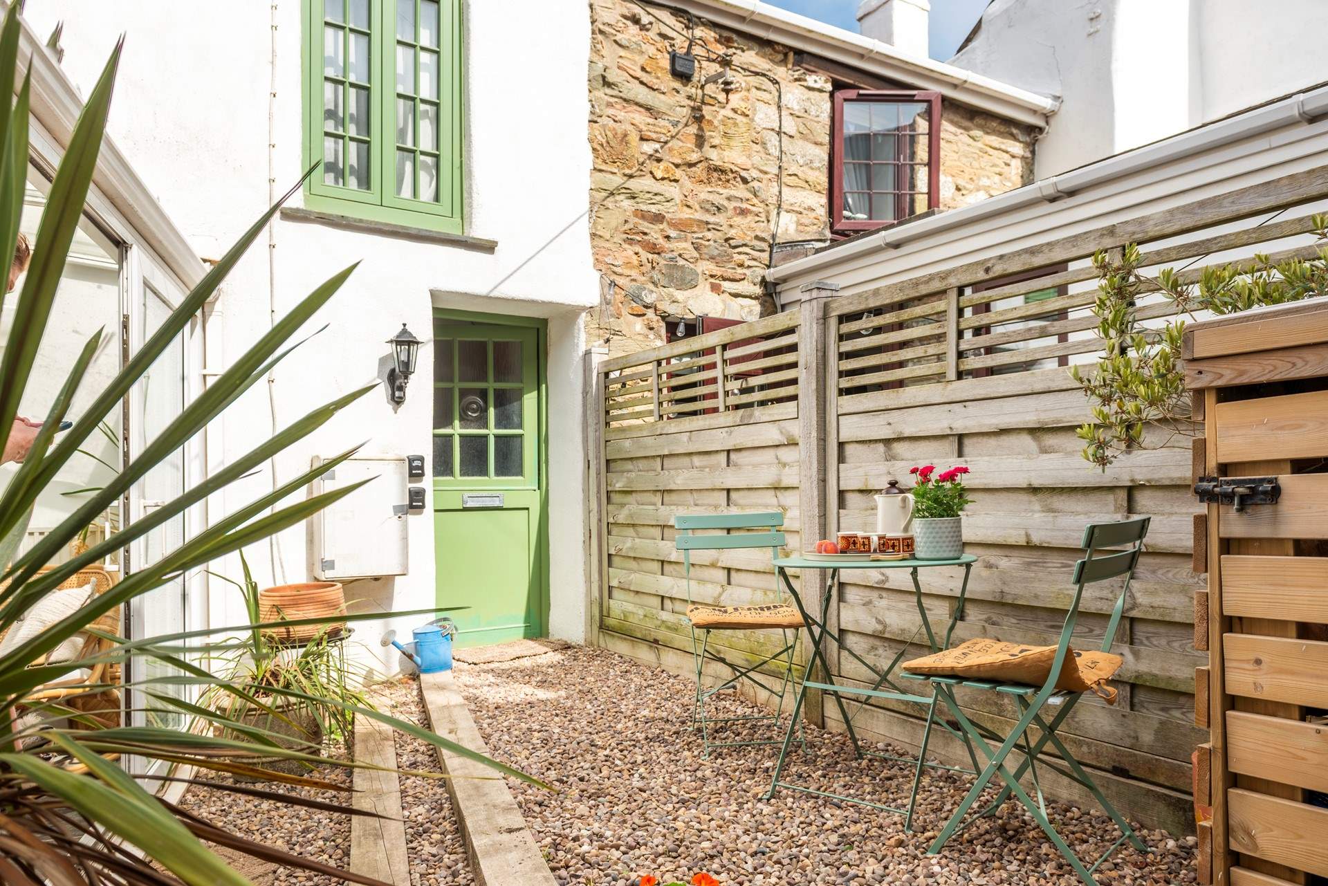 The sunny courtyard garden, with two steps down to the conservatory/dining-room. 