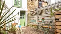The sunny courtyard garden, with two steps down to the conservatory/dining-room. 