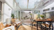 The bright and sunny dining-area overlooks the courtyard garden. 