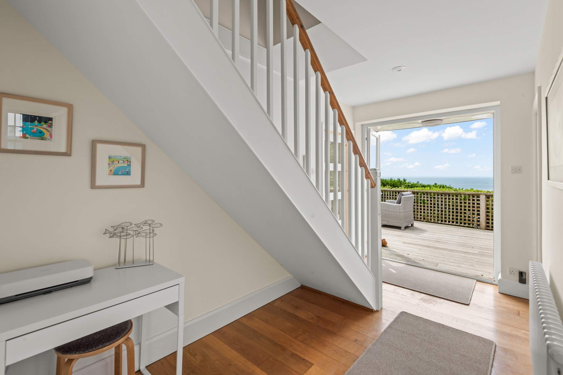 The stairs lead up from the hallway which also opens up to the decked balcony.