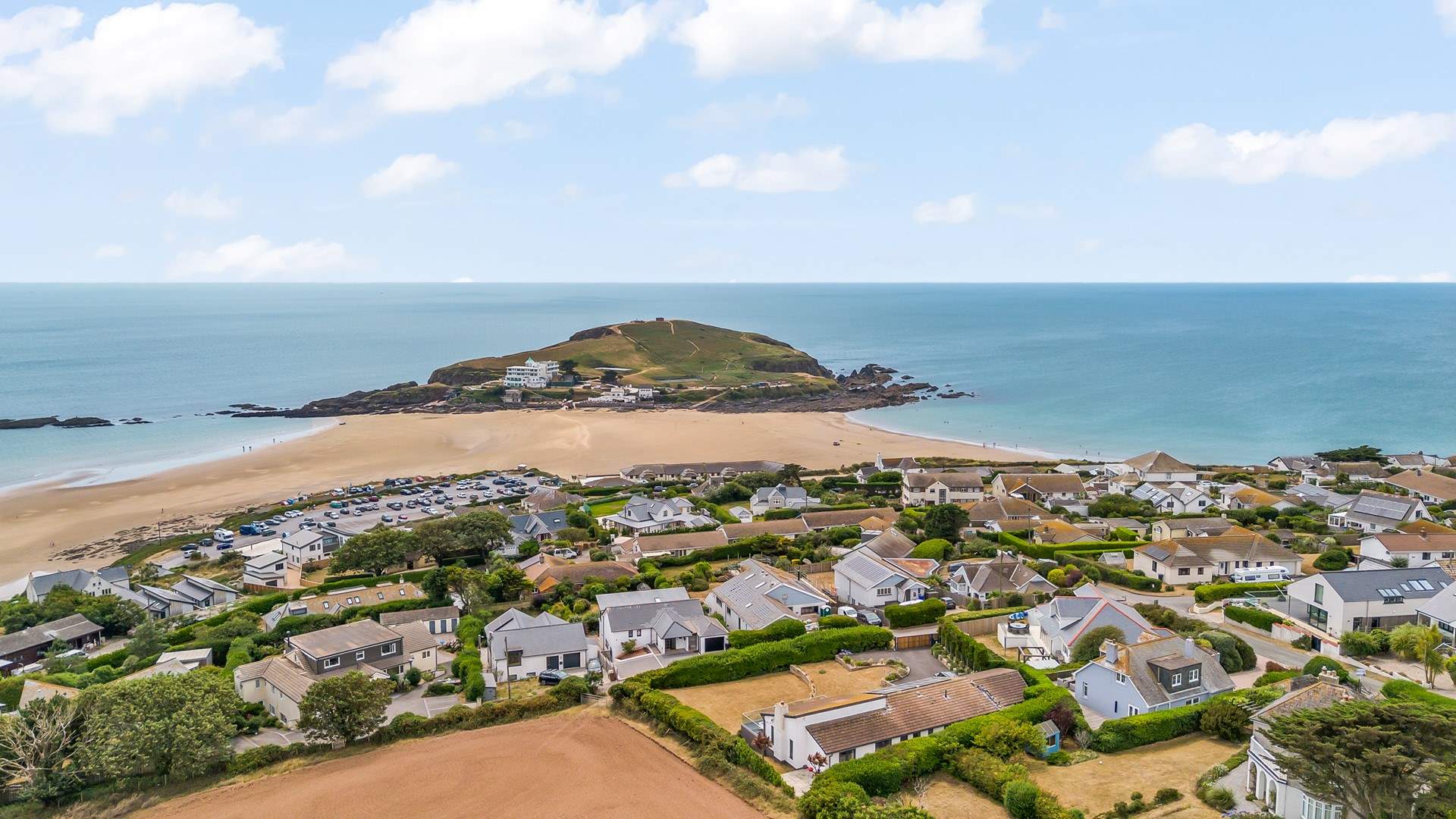 A hop, skip and a jump will find you on the glorious sands of Bigbury beach. Island Cottage is featured in the bottom right-hand corner of this image.
