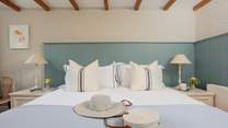 A comfortable king-size bed in bedroom 1.