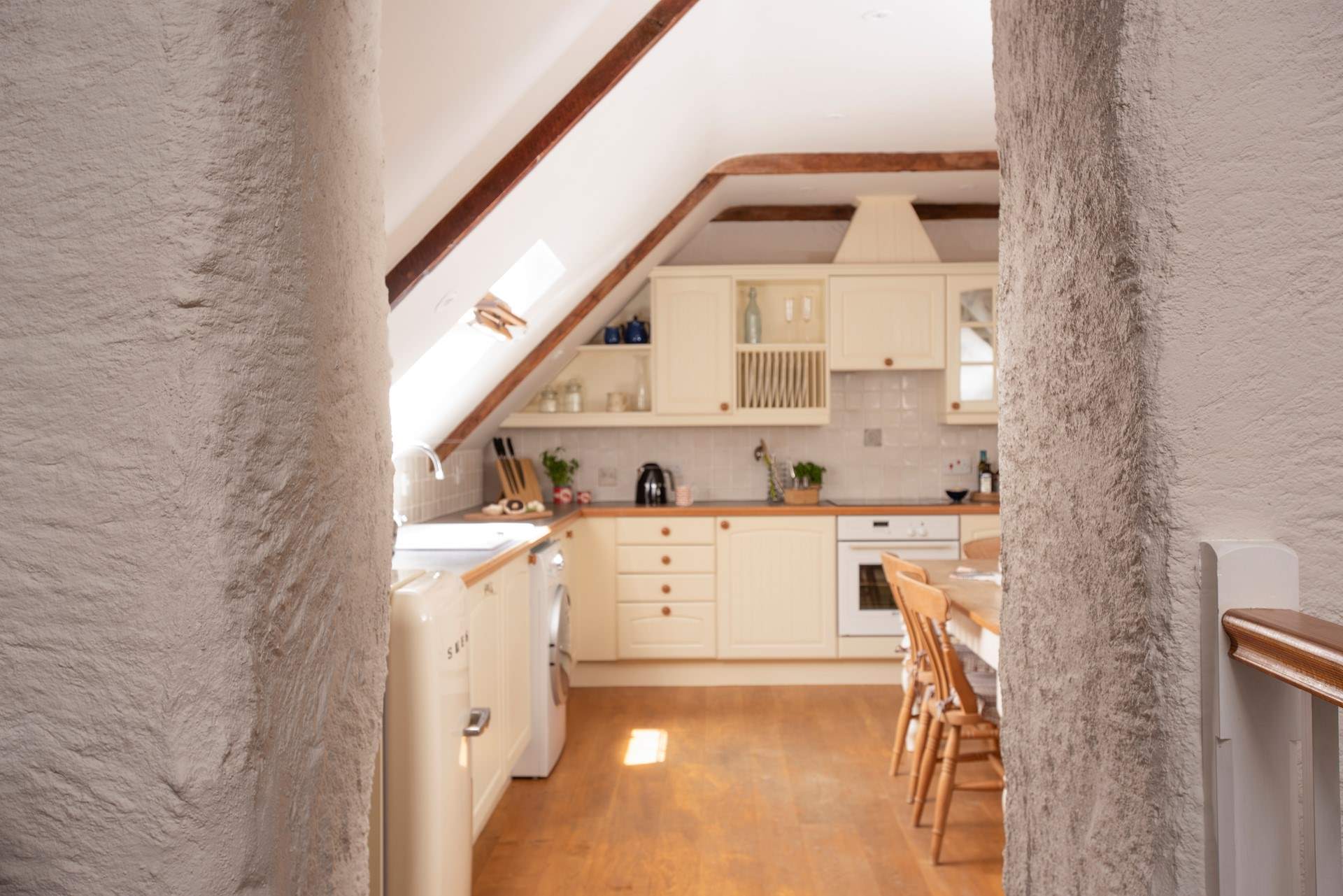 The original thick walls and beamed vaulted ceilings add to the overall charm and character. 