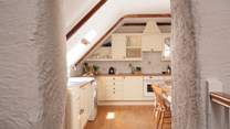 The original thick walls and beamed vaulted ceilings add to the overall charm and character. 