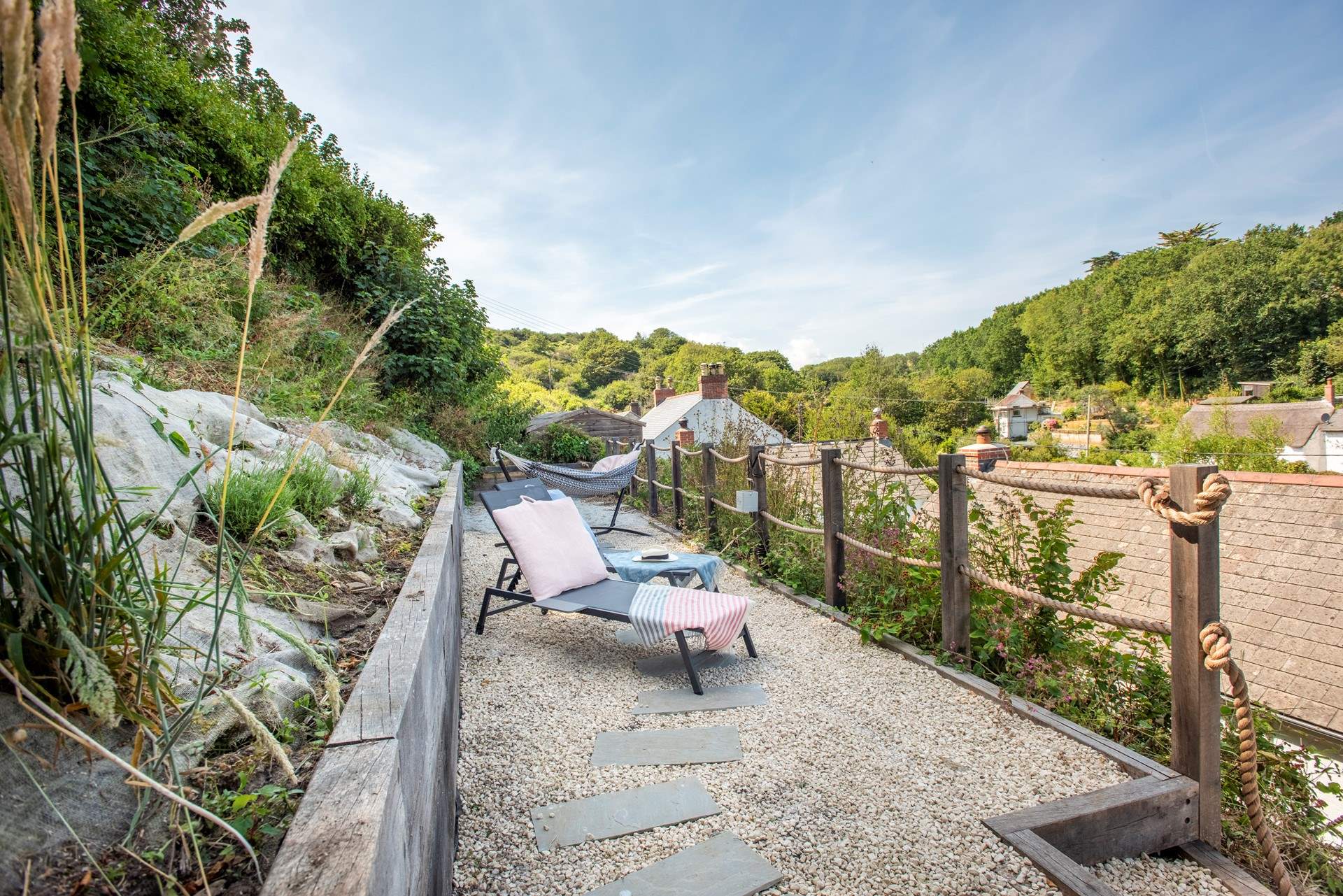 There are sun-loungers and dining furniture.