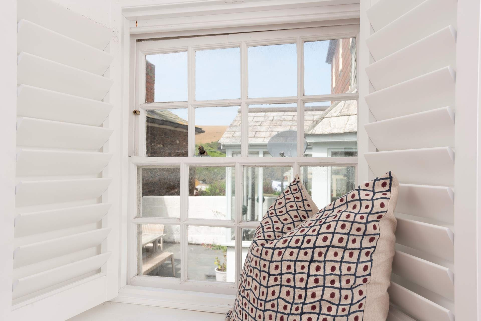 Classic shutters frame the windows.