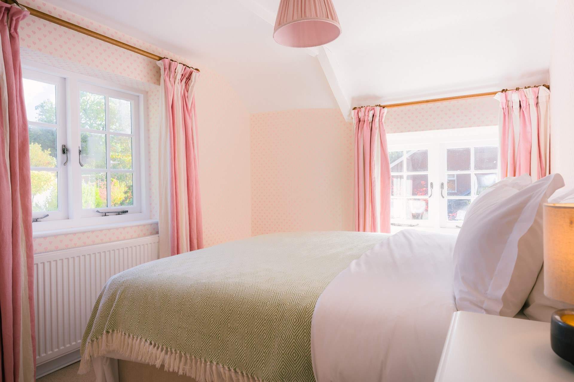 Across the hall the next bedroom is just lovely with its dual-aspect and another view of the Tor.