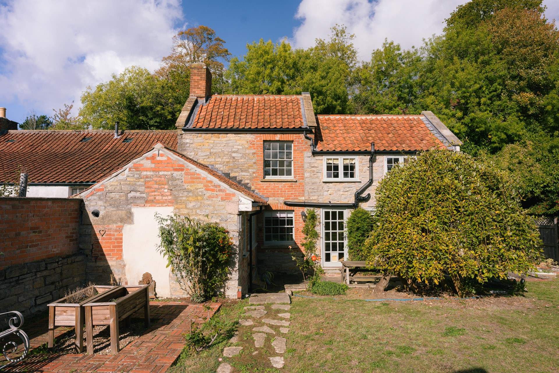 The cottage is pretty as a picture on a sunny afternoon.