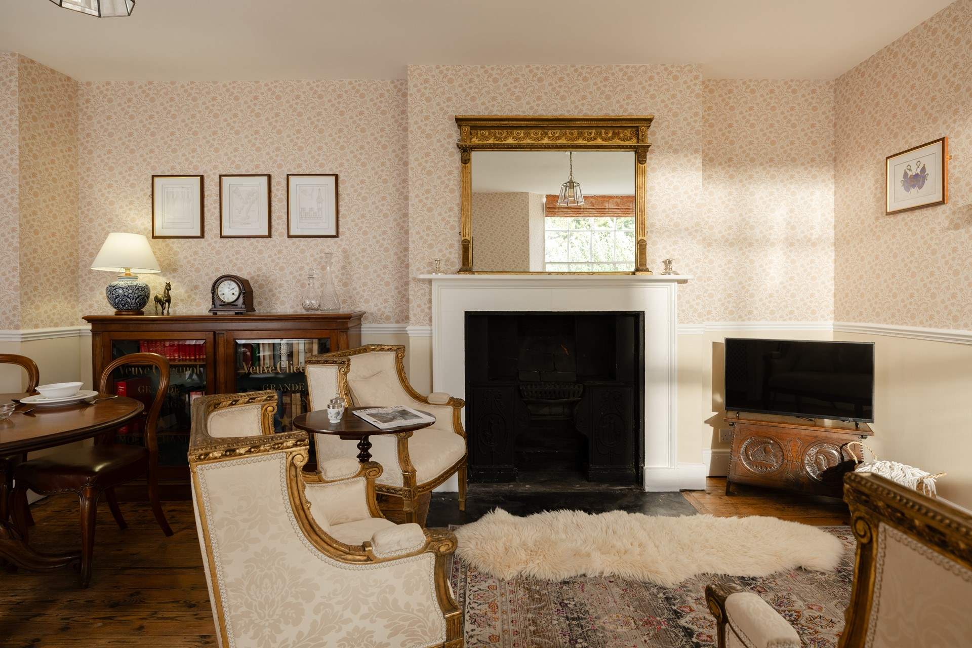 The sun streams into the sitting/dining-room. The fireplace is ornamental only.
