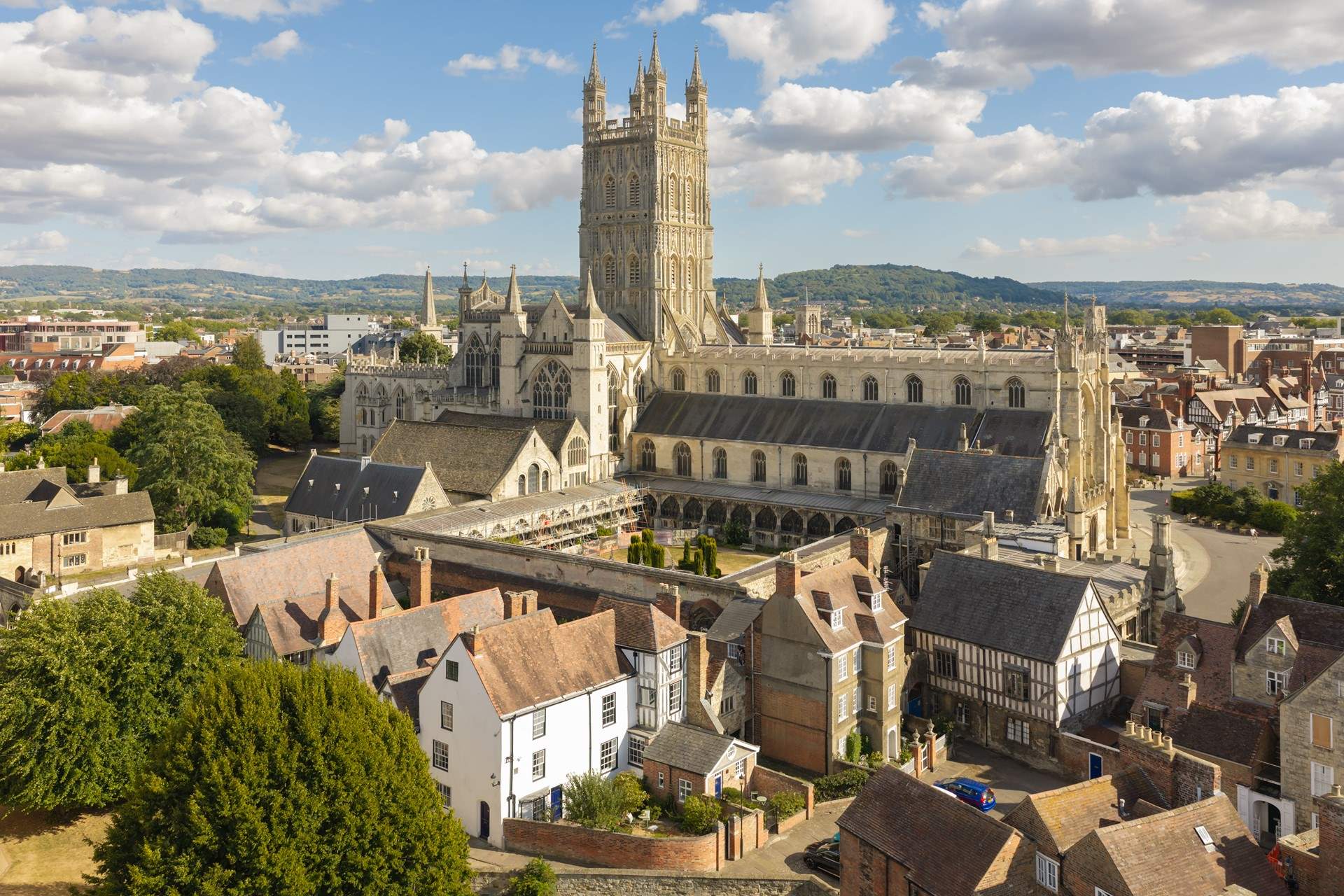 Gloucester Cathedral with its cloisters and the countryside in the background. 