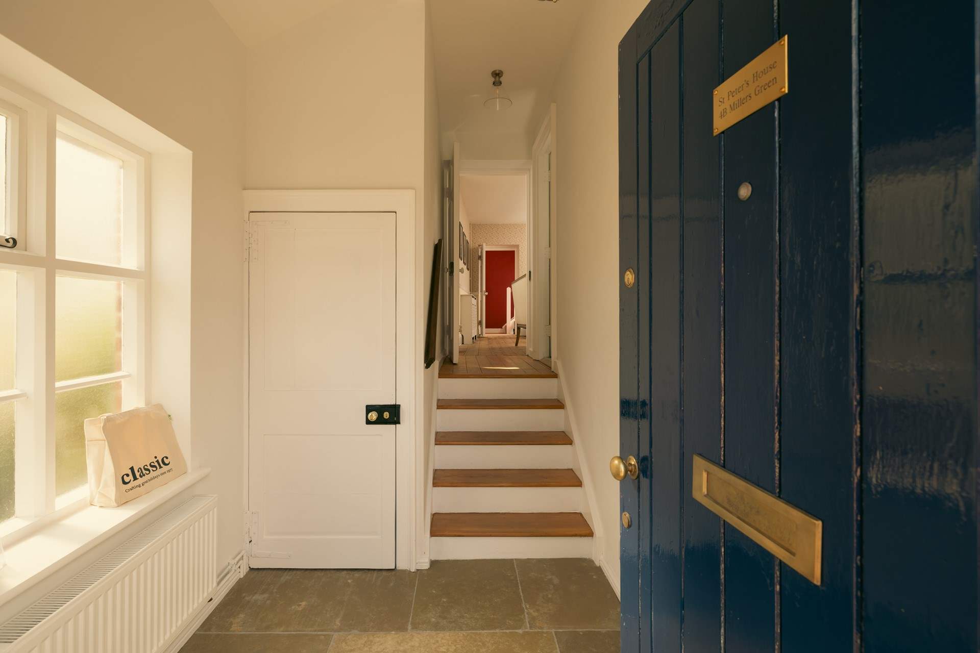 The hallway has a few steps up to the kitchen and sitting/dining-room. 