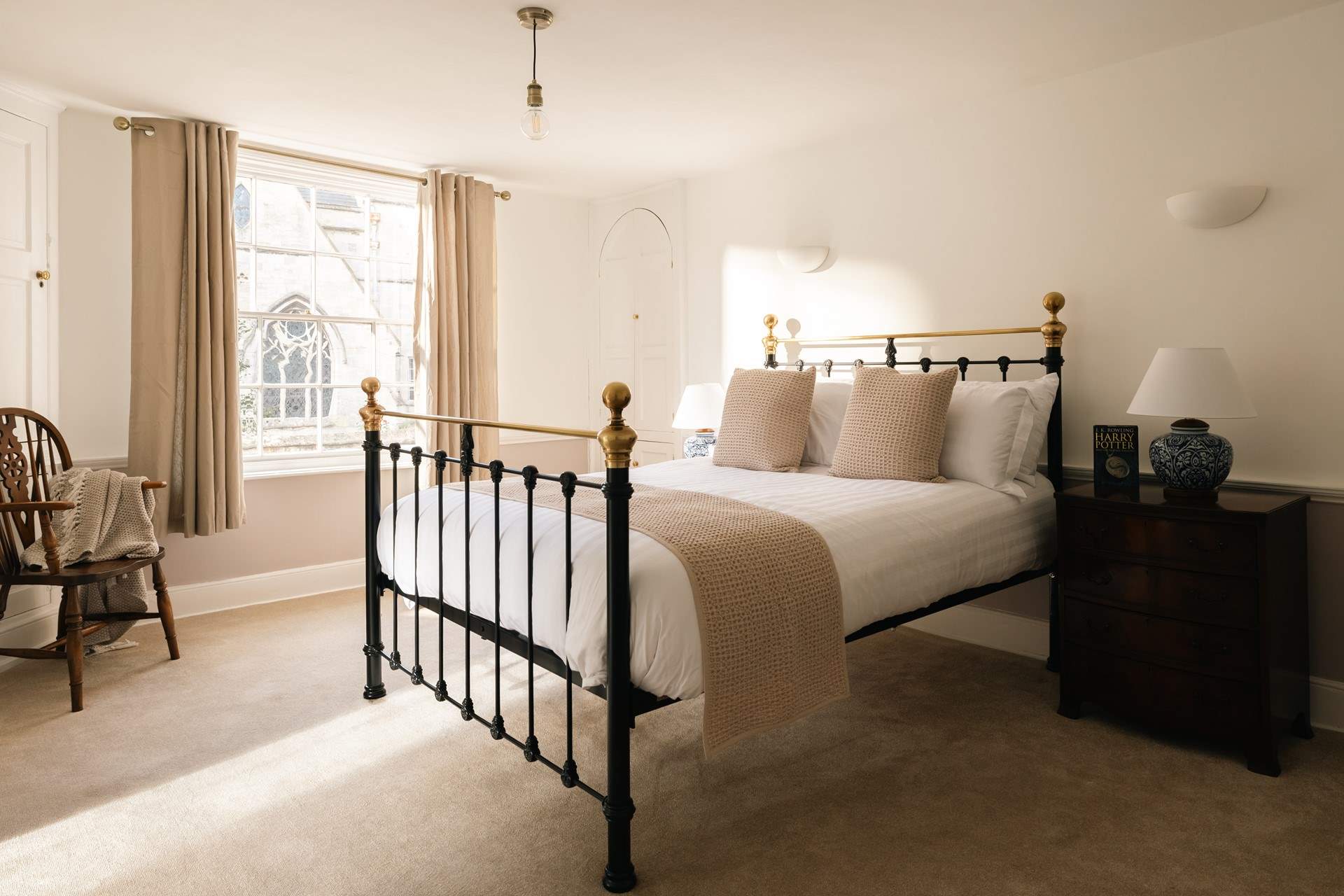 Cool, calm neutral tones make this a relaxing bedroom, and look at the view from the window. 